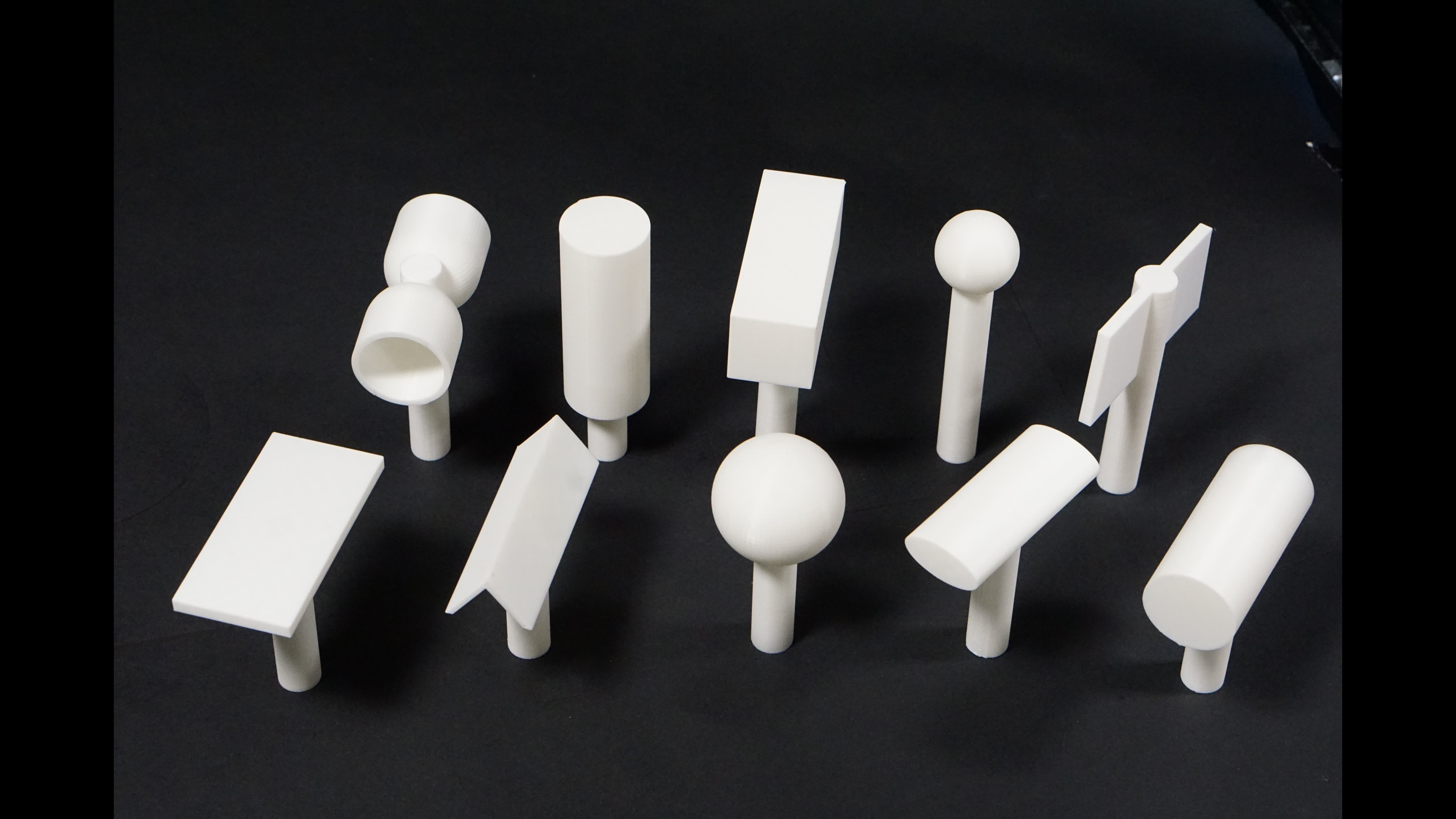 Ten 3D-printed objects with point, edge, and area contact geometries used for paired data collection.